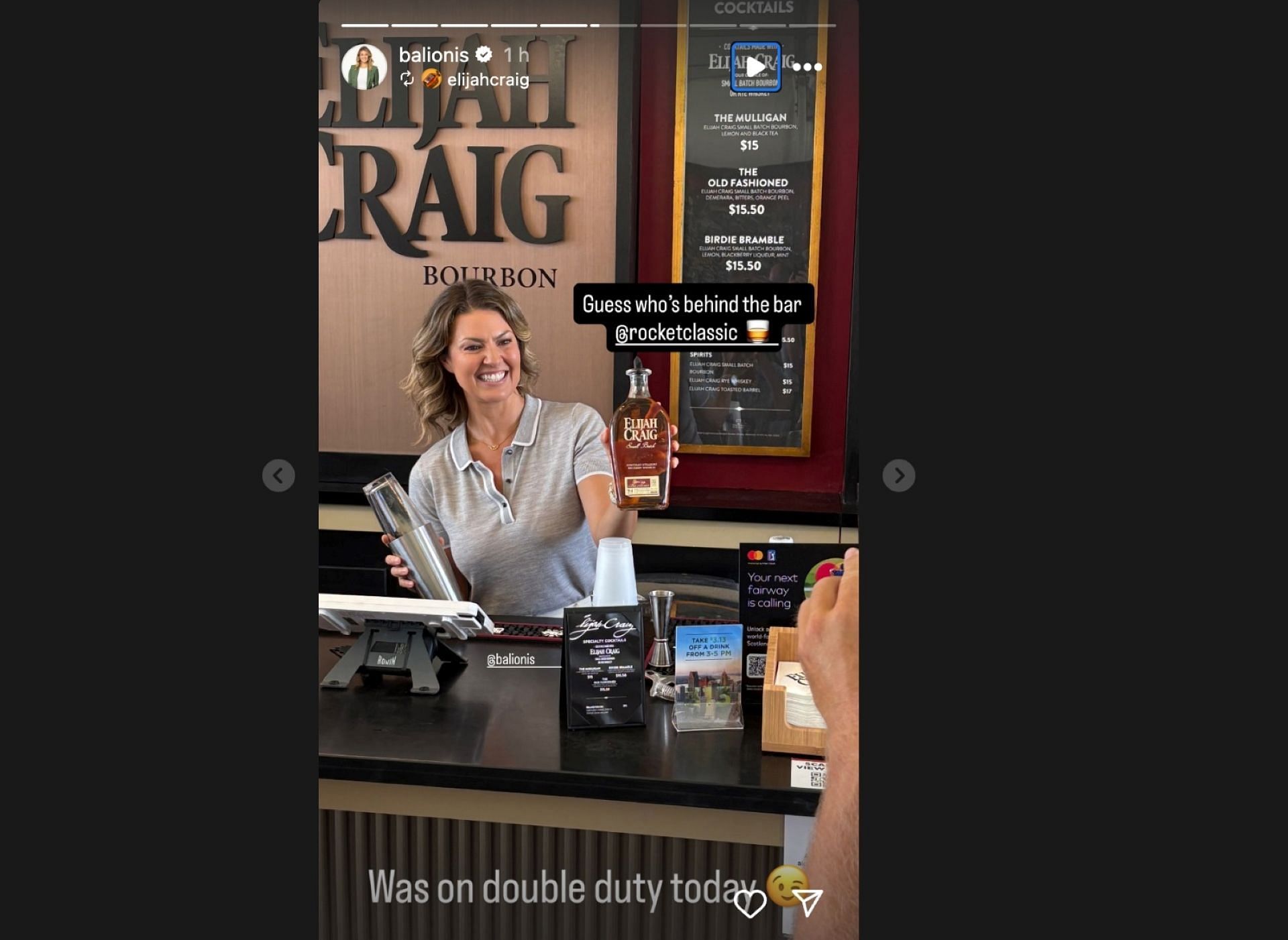 Amanda Balionis poses behind the bar at the Rocket Classic, holding a cocktail shaker and a bottle of Elijah Craig bourbon (via @balionis)